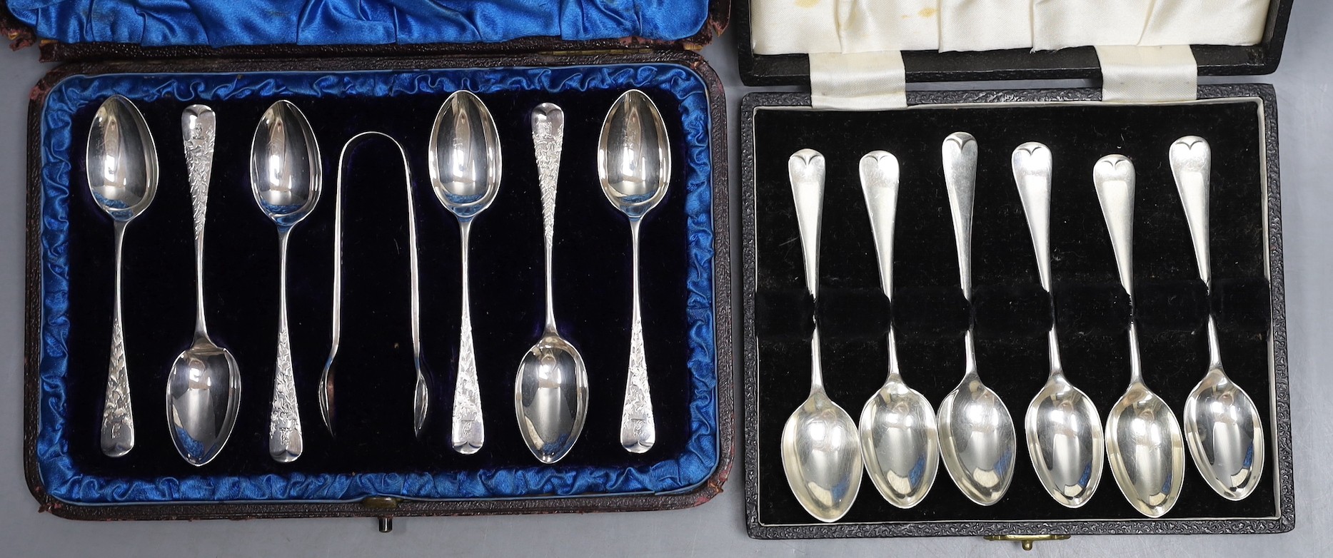 Two cased sets of six silver coffee spoons, including A Victorian set with sugar tongs, the other modern set with picture back bowls.